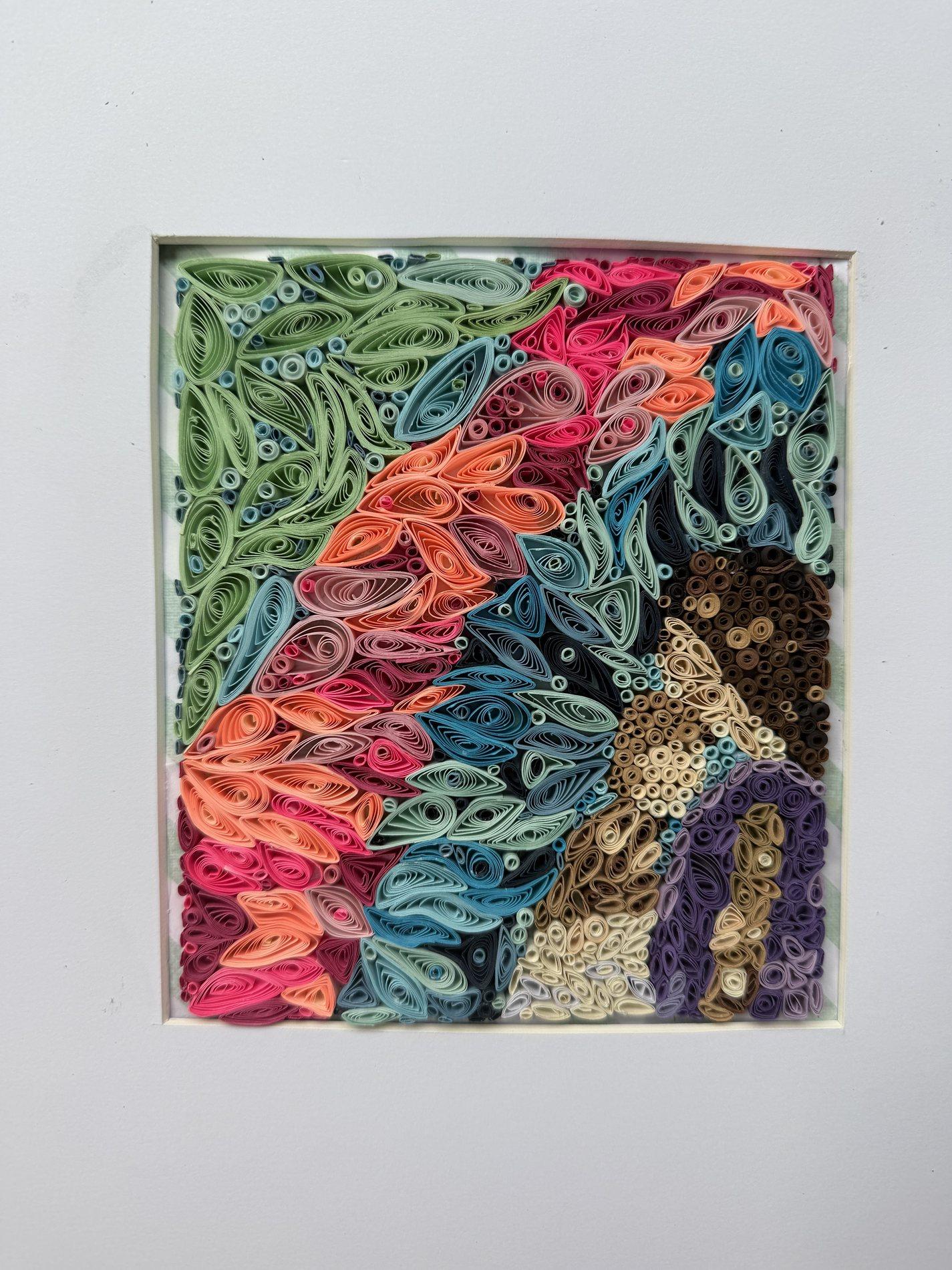 Colorful quilling landscape in green, coral, blue, brown, and purple paper