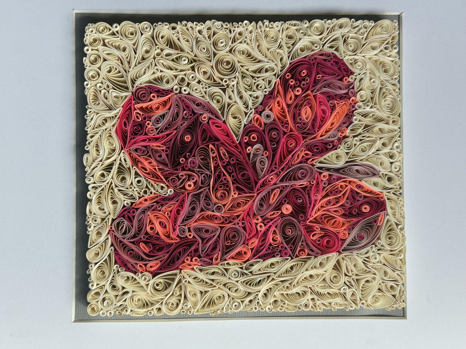 Curled red fox quilling artwork surrounded by cream paper shapes