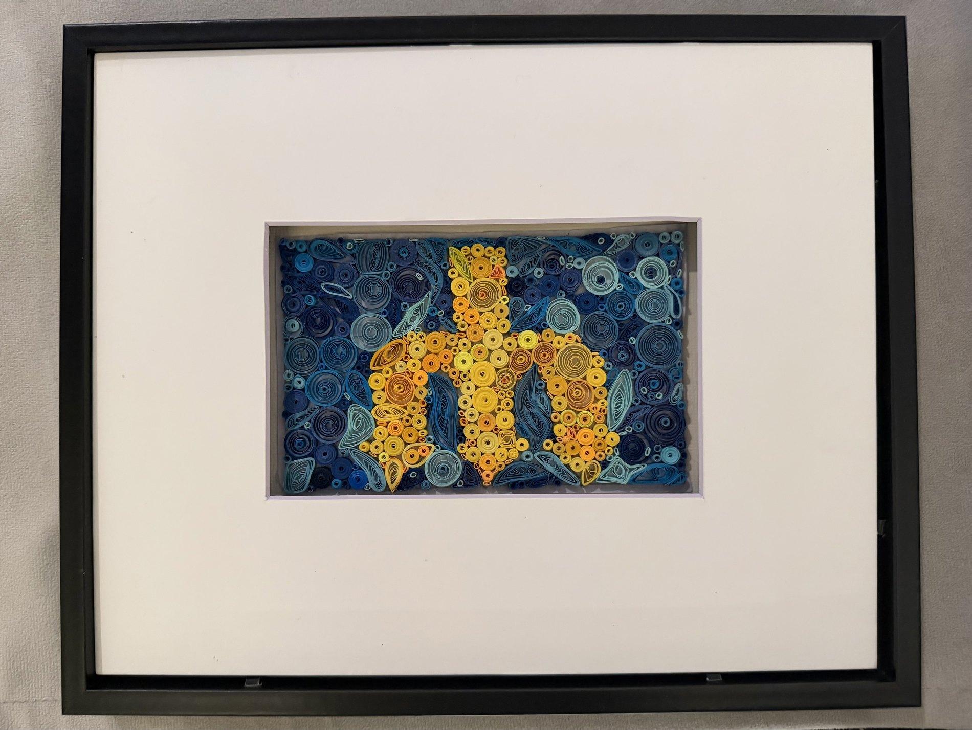 Yellow sea star quilling artwork on a blue background