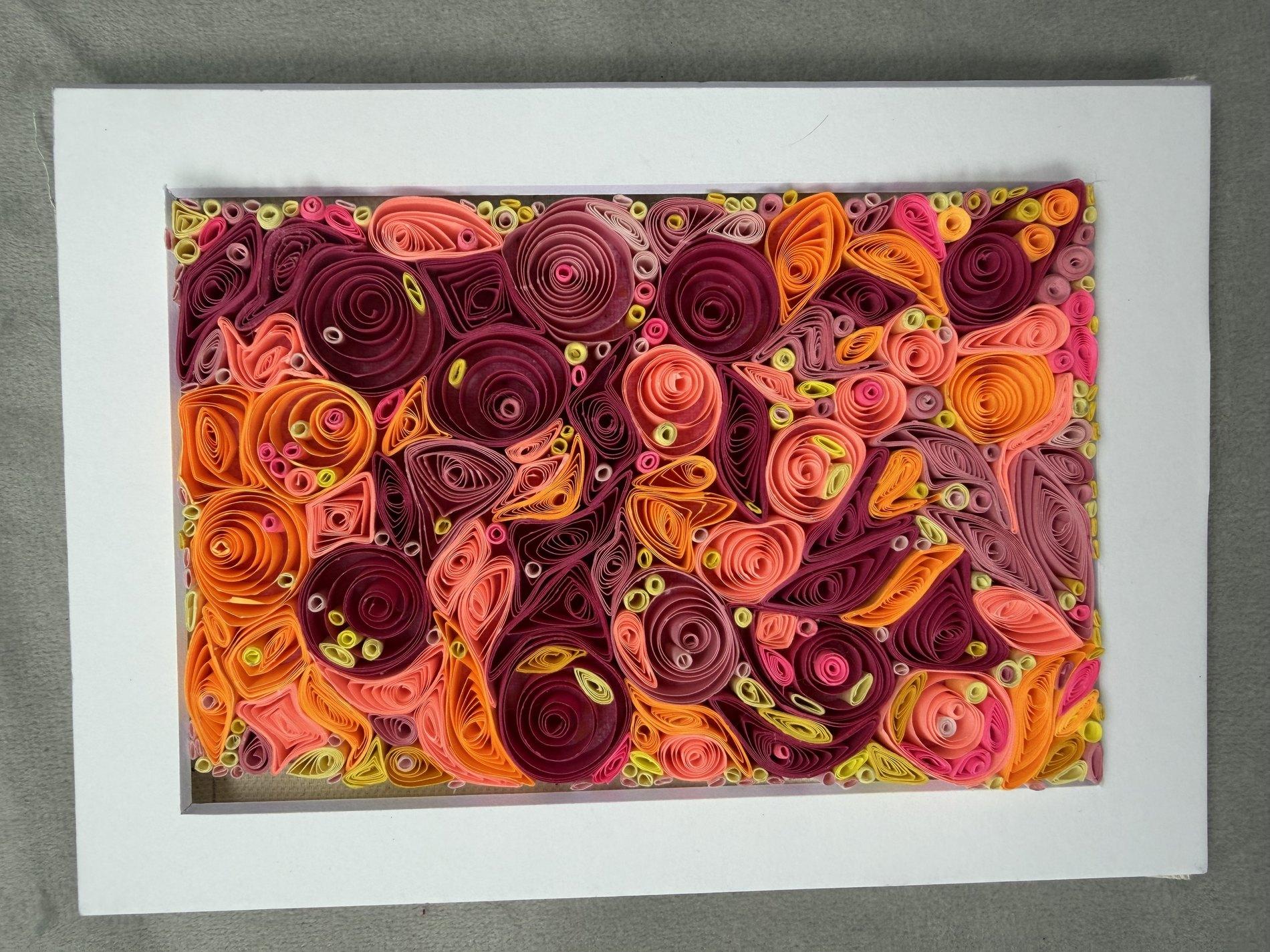 Warm floral quilling artwork in pink, orange, burgundy, and coral paper